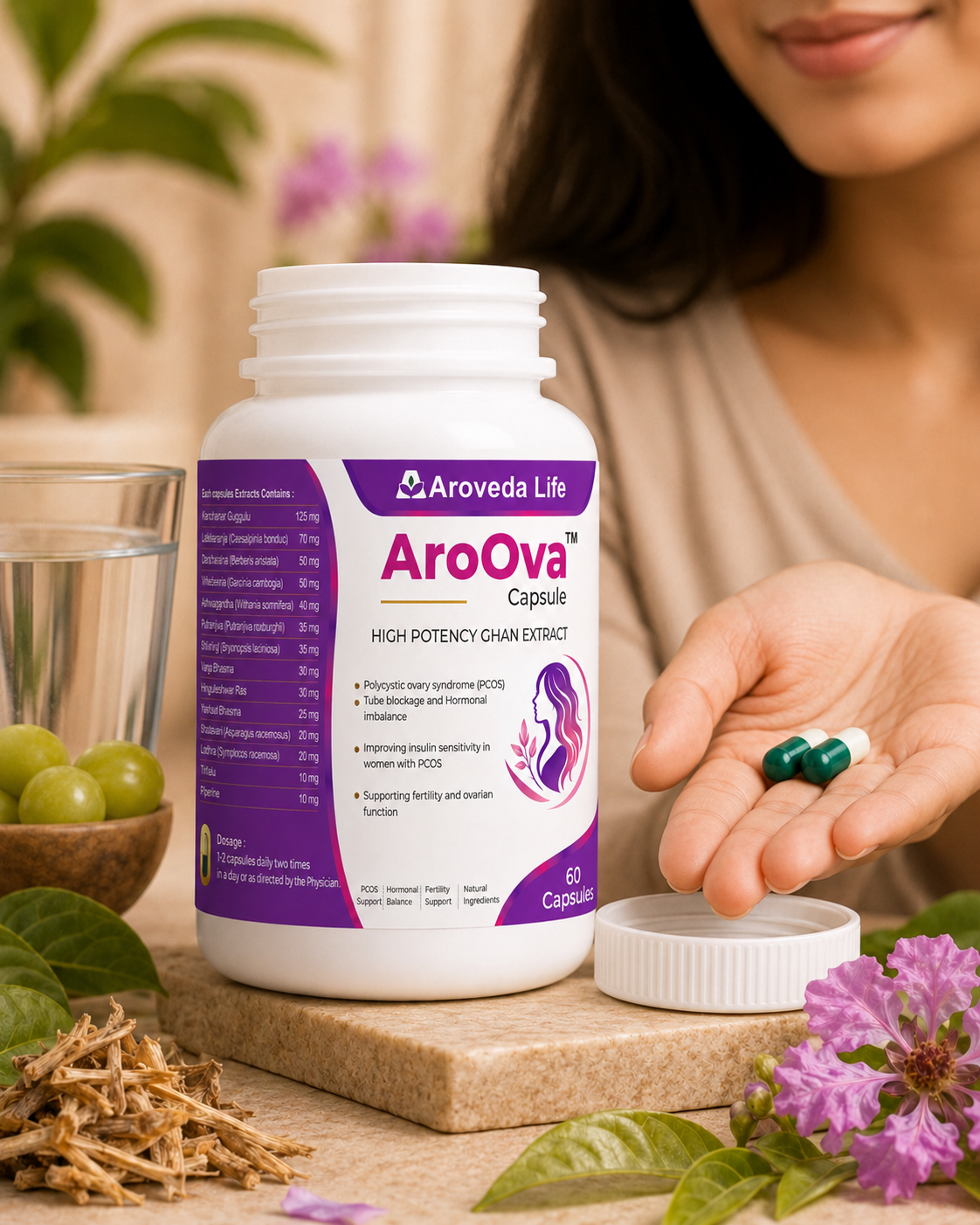 A white bottle of AroOva High Potency Chain Extract capsules by Aroveda Life sits on a stone slab with its cap off, next to a hand holding two capsules. The scene is styled with green grapes, dried herbs, and purple flowers, with a woman's hand and lower face visible in the background.